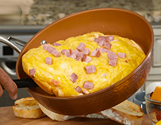 Omelet sliding out of Gotham Steel™ Hammered Pan